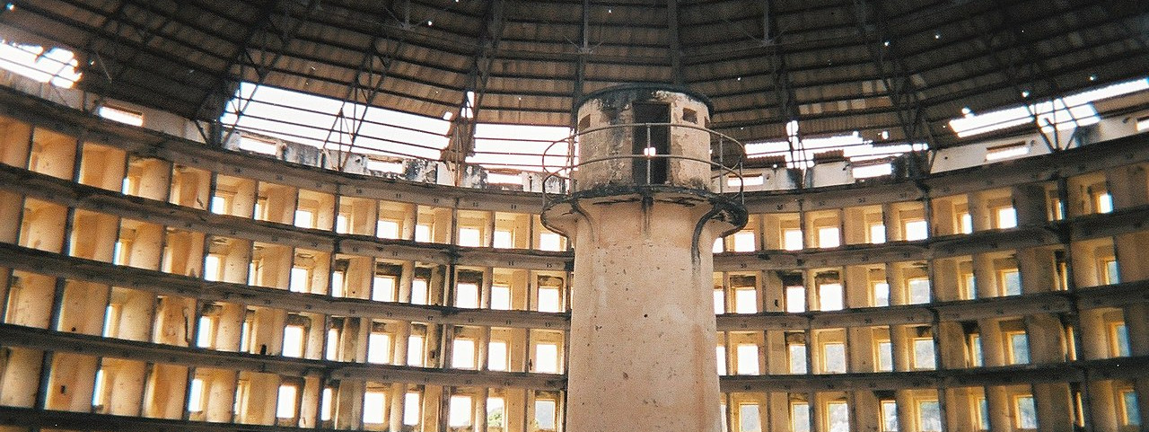 Old panoptic prison in ruins. A central tower which observes each cell
